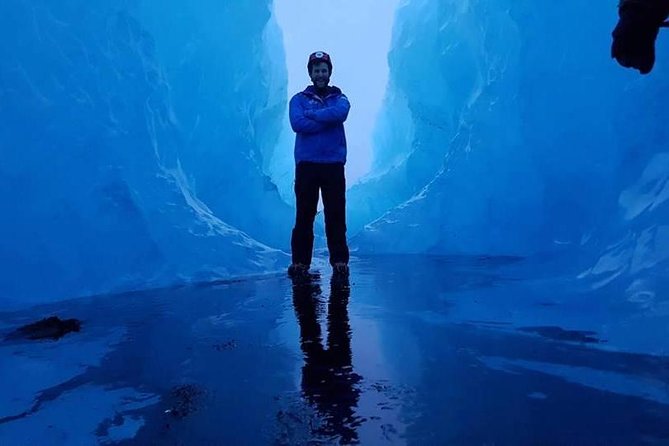 Crystal Blue Ice Cave Adventure - Entering the ice cave with a guide