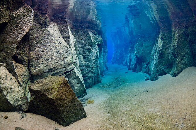 Double Snorkeling Adventure near Húsavík in North Iceland - Entering the clear water at Nesgjá